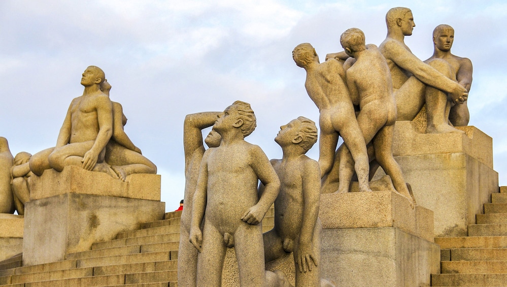A stone sculpture of reclining and standing figures. 4