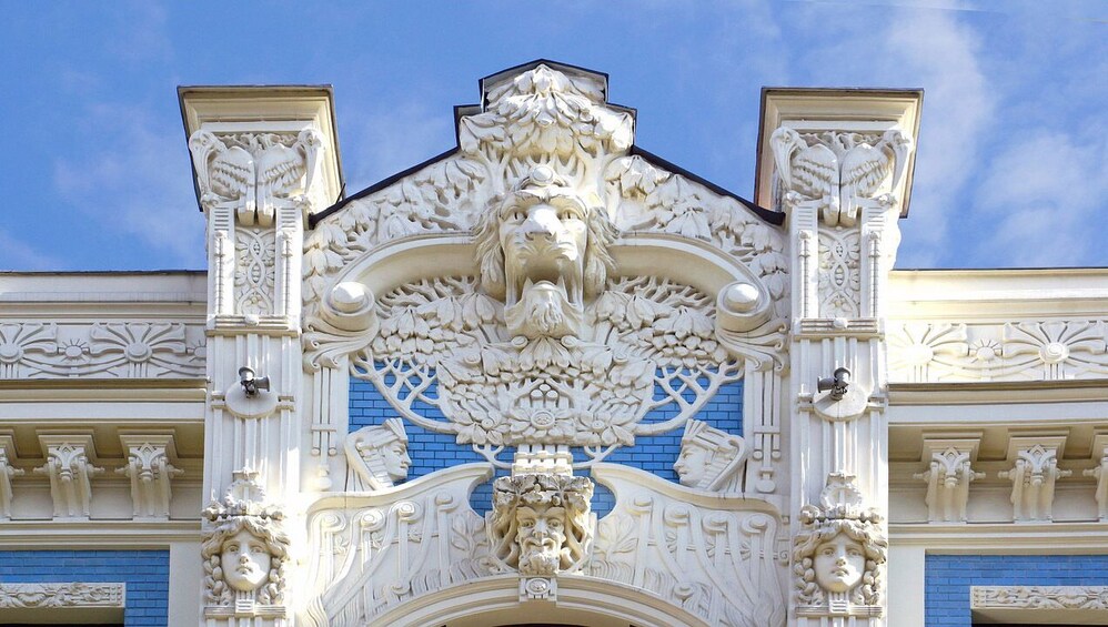 Ornate architectural details with intricate carvings and a blue patterned wall. 1