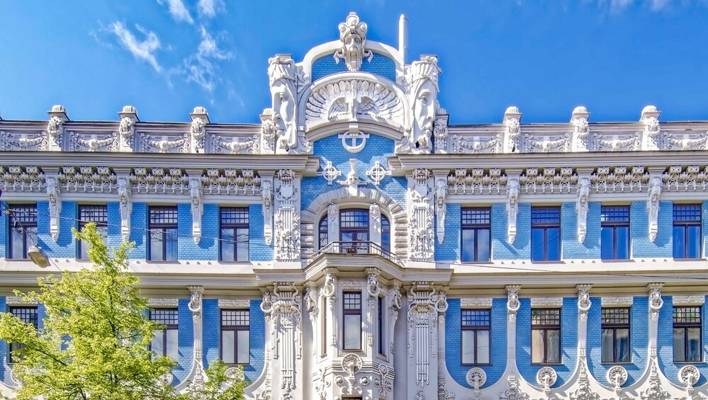 A grand building with ornate white and blue architectural details, including statues and decorative columns. 4