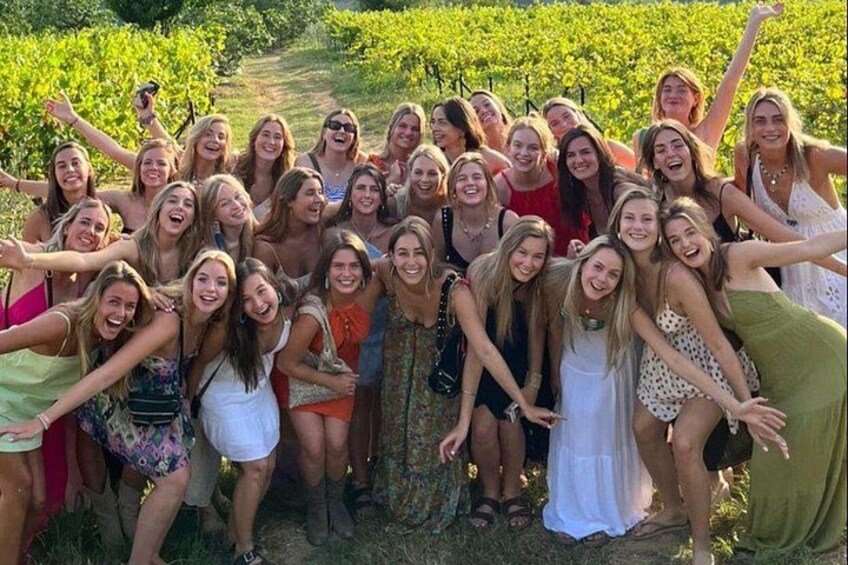 A group of people in a vineyard. 2