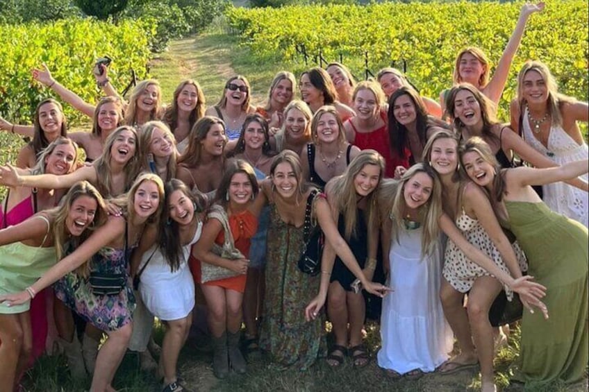 A group of people in a vineyard. 2