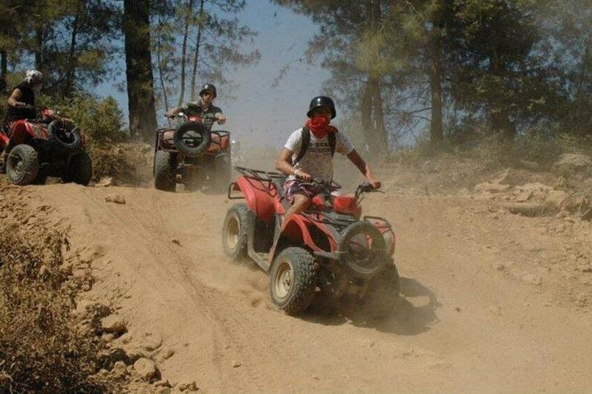 Off-road vehicles on a dirt path surrounded by trees. 4