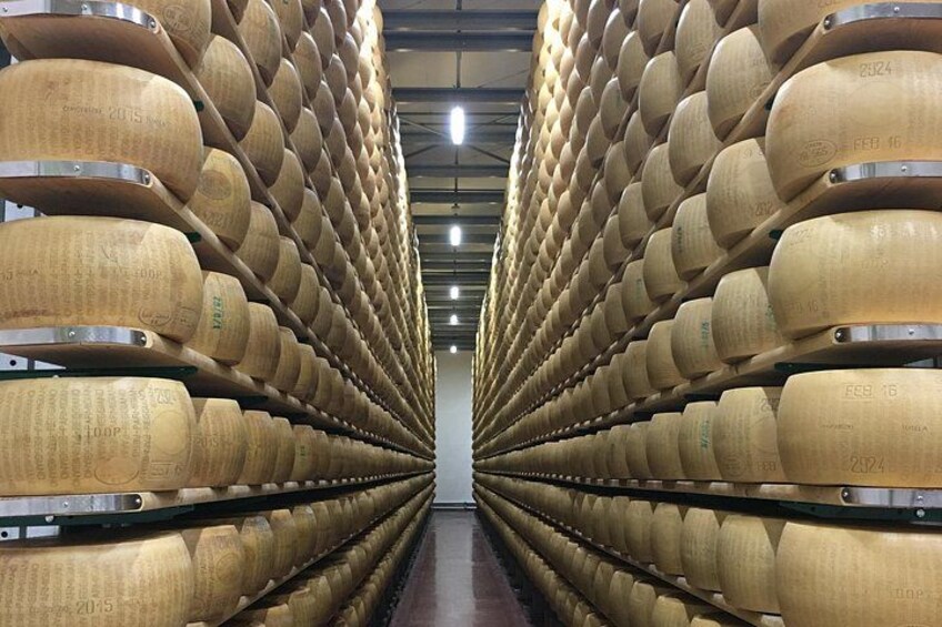A warehouse with rows of large wooden barrels. 2