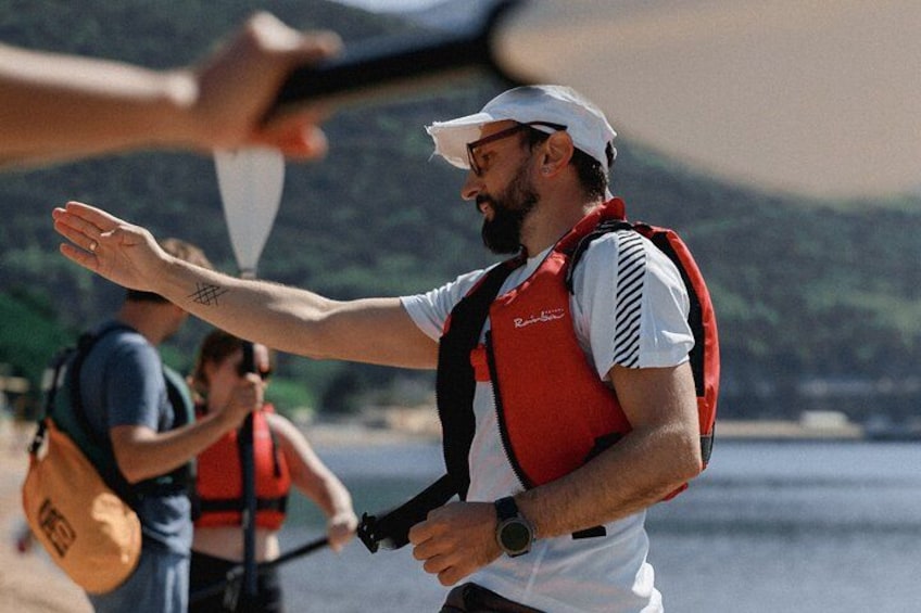 Budva Bay Kayak & SUP Tour to Coastal Caves – guide instructing guests in life vests before kayak launch at Budva Bay, Montenegro 3