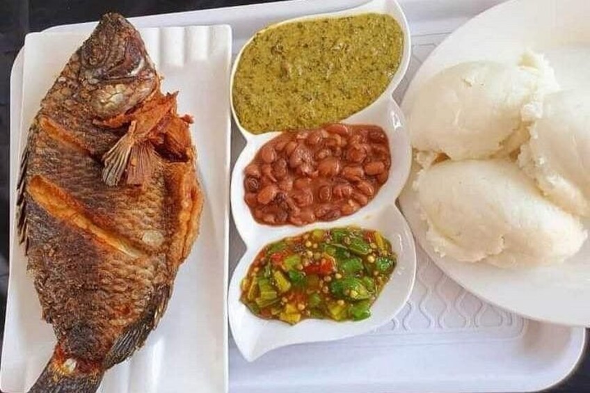 A whole grilled fish, two types of bean dishes, and a plate of white rice. 2