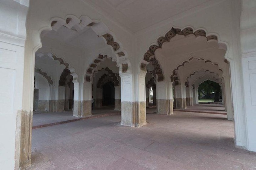 An interior corridor with arches and columns. 1