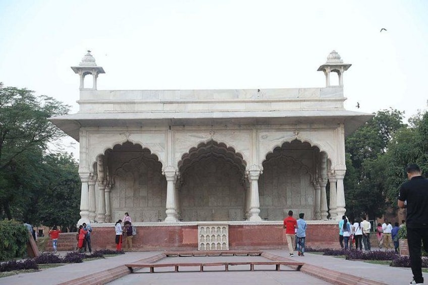 A white marble structure with arches and a central courtyard. 5