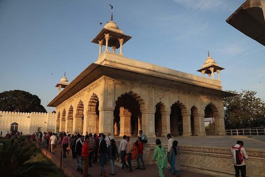 A large, ornate building with multiple domes and arches, surrounded by a crowd of people. 4