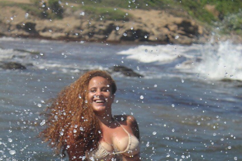 Eine Person im Badeanzug in der Nähe von Wasser mit Wellen. 3