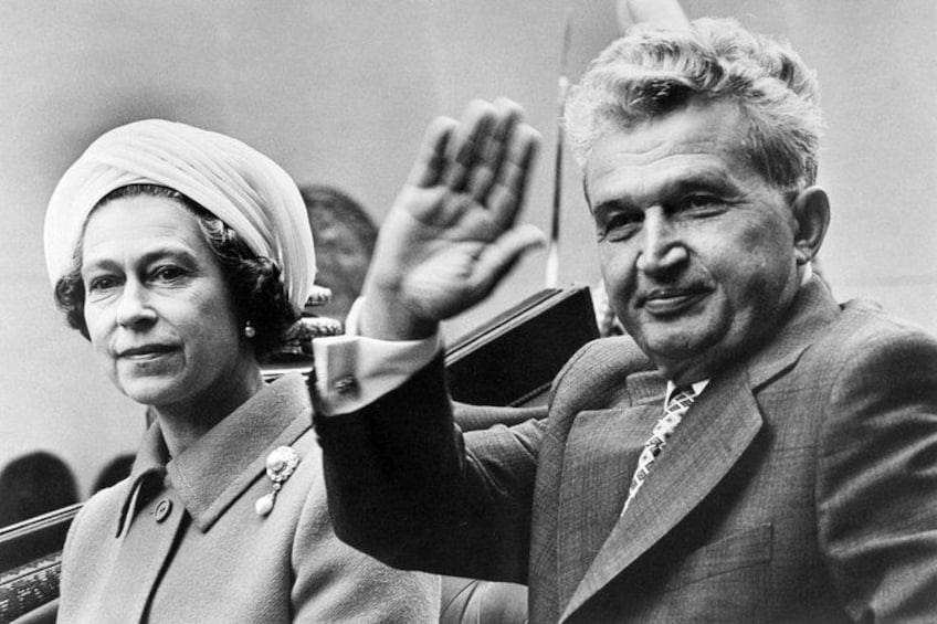 Two people in formal attire, one raising a hand. 5
