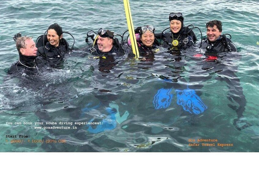 A group of people in scuba diving gear in the water. 4