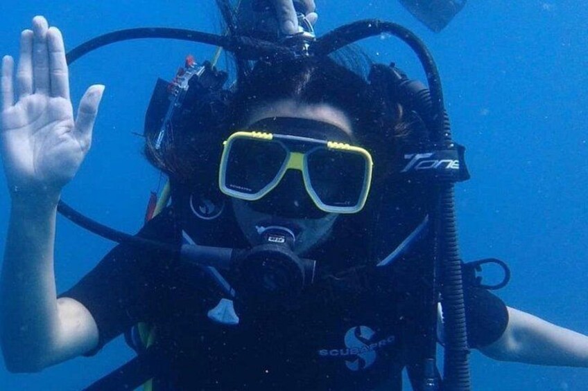 A person underwater with a scuba diving mask and breathing apparatus. 5