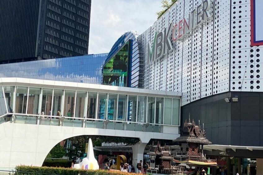 A modern building with a glass facade and the sign 'MBK CENTER' above it. 4