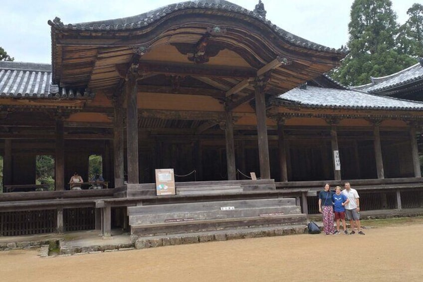 A traditional Japanese building with a curved roof and wooden pillars. 1