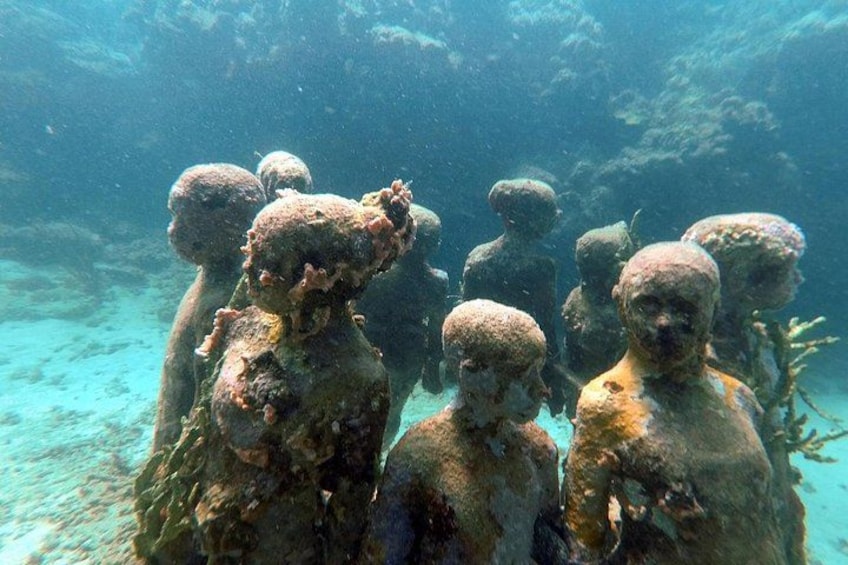 Underwater sculptures resembling human figures. 2