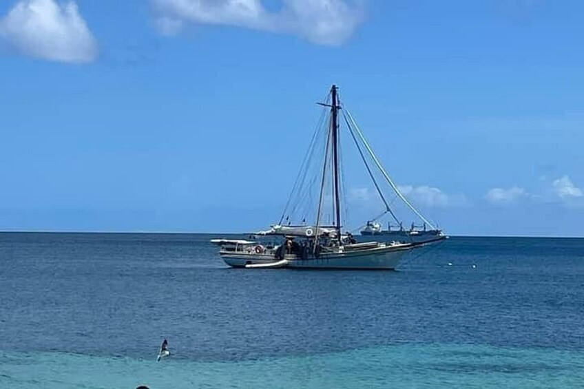 A sailboat on calm ocean waters with a clear sky. 4
