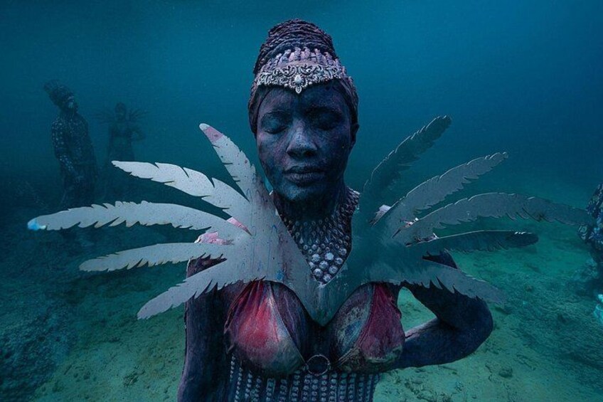 A person underwater with a unique shell-like structure on their chest. 5