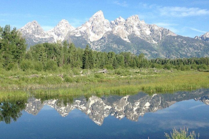 A mountain range with a lake reflecting the peaks. 2