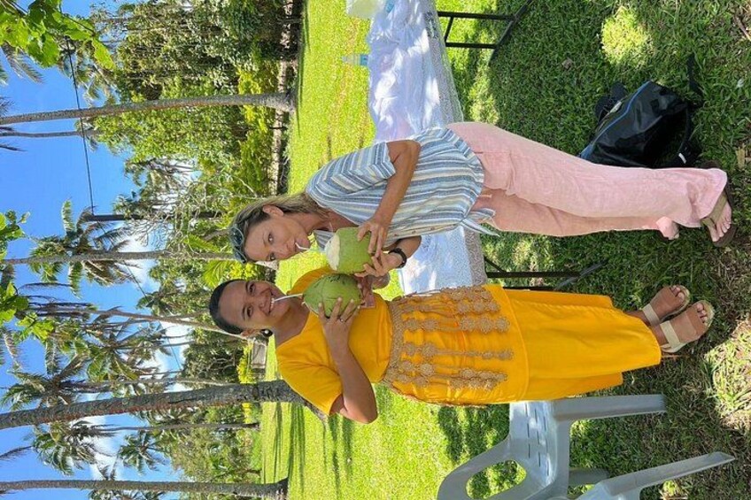 Quen enjoying a coconut with lovely guest Erin at Anahulu Cave as part of the Cultural Tour 2