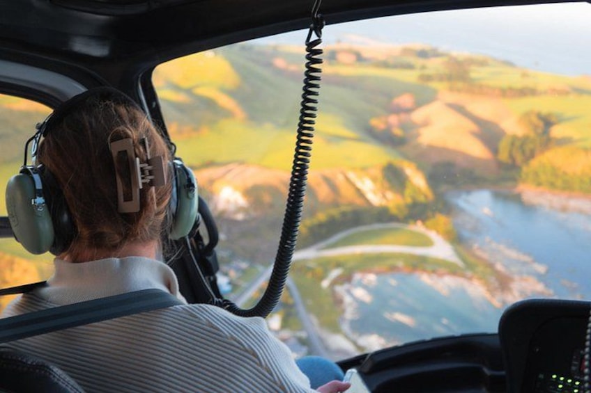 Une personne se trouve dans le cockpit d’un hélicoptère, avec une vue sur le paysage. 2