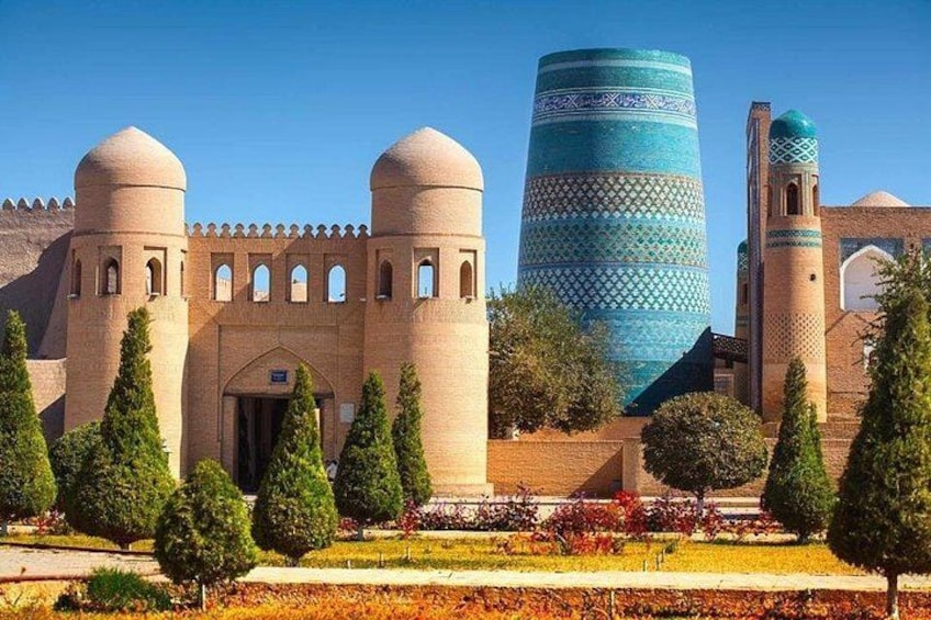A historic building with domed towers and a cylindrical tower with blue patterns. 1