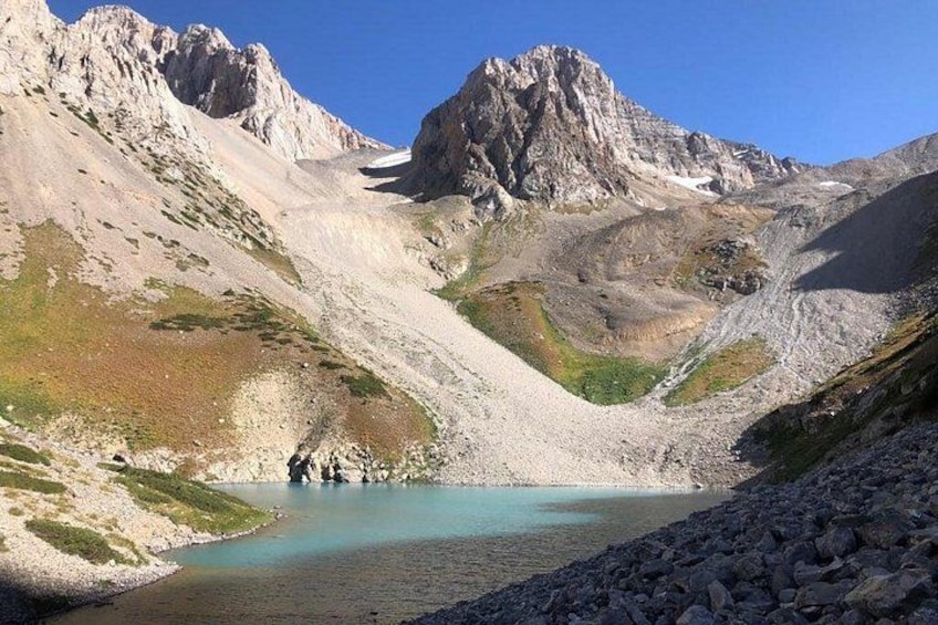 A mountain lake surrounded by rocky terrain and steep cliffs. 1
