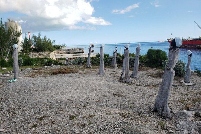 A coastal area with wooden posts, a rocky shore, and a distant ship. 2