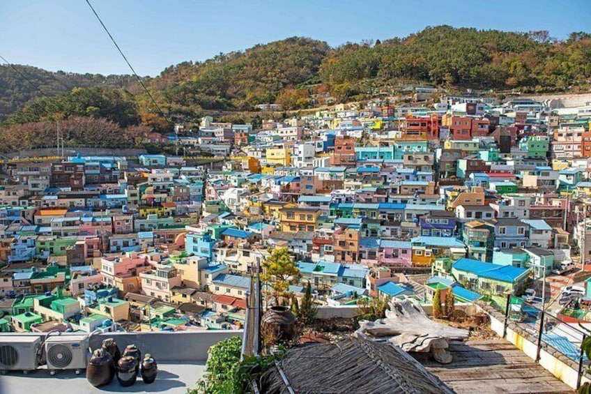 A densely packed hillside town with colorful buildings. 3