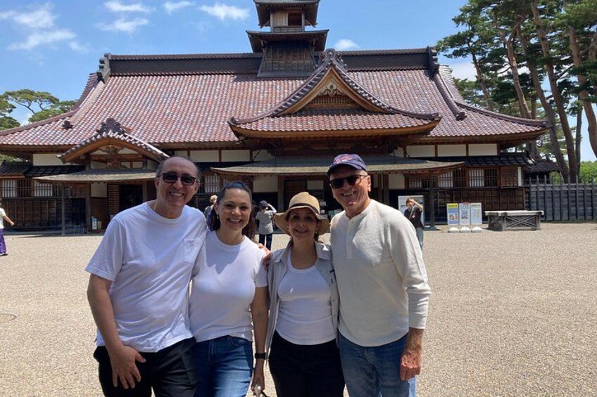 A traditional Japanese building with a tiled roof and wooden structure. 2
