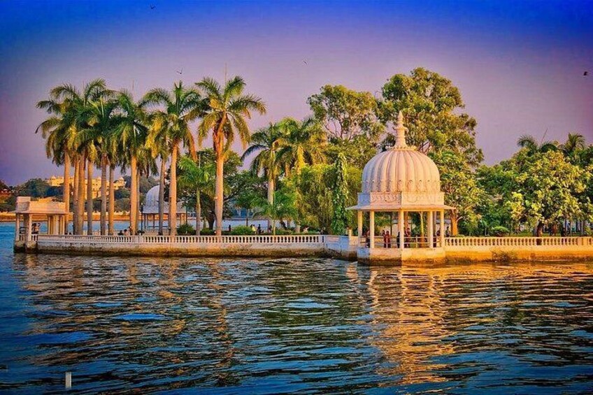 A water body with a gazebo and palm trees. 4