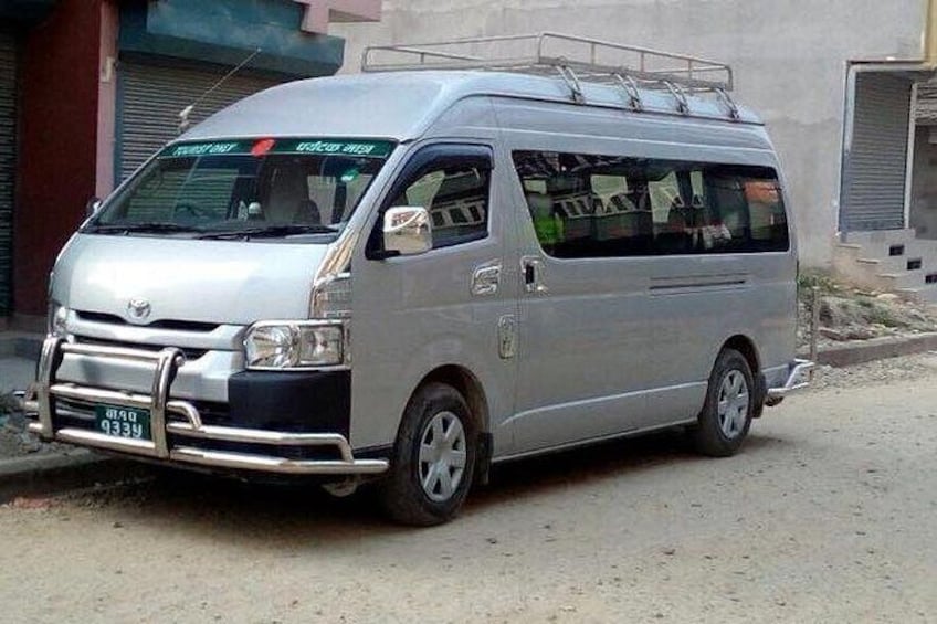 A silver van parked on a street. 2