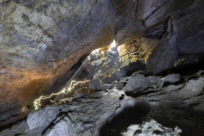 A cave with a metal staircase and a lightning effect. 2