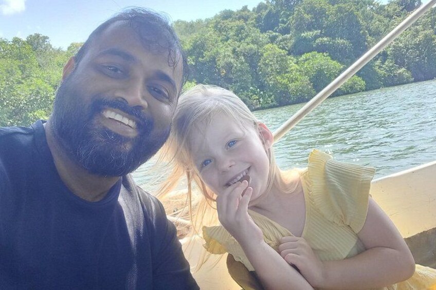 A person in a boat with a forested landscape in the background. 1