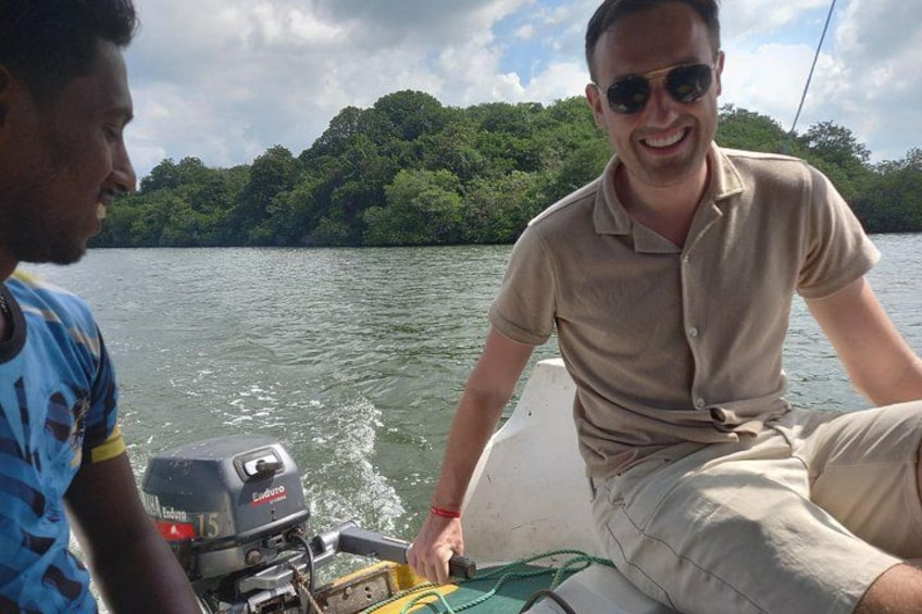 A person on a boat with a motor, surrounded by water and greenery. 2