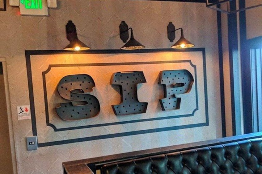 A wall with the letters 'SIP' illuminated by spotlights. 5