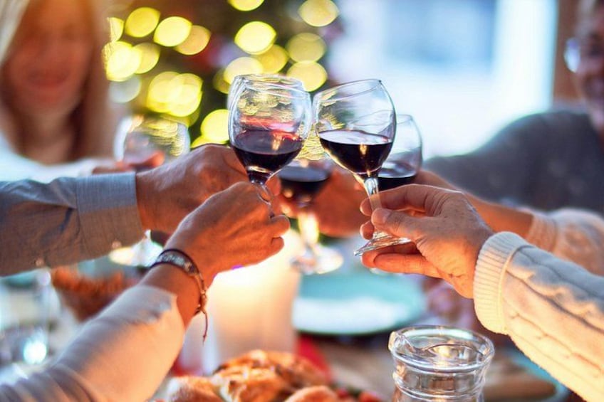 A group of people toasting with wine glasses. 2