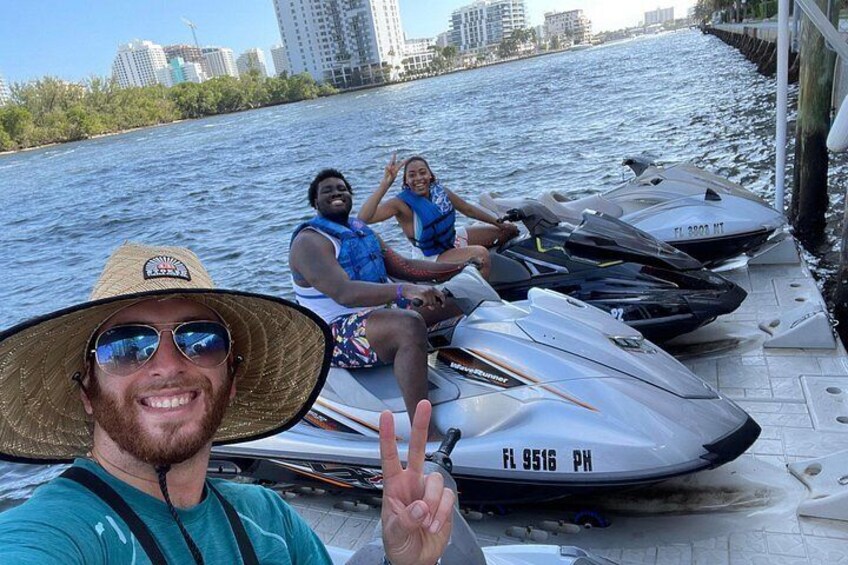 A jet ski on a dock with a city skyline in the background. 3