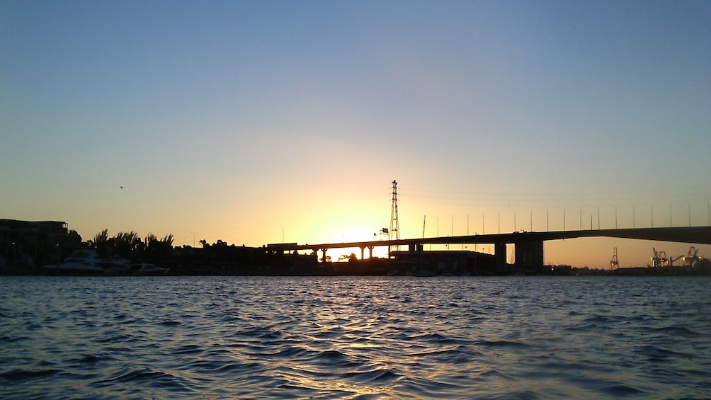 setting sun over waters and city in Melbourne  