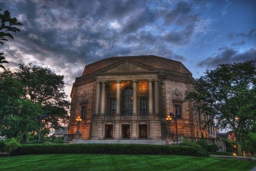 A large, historic building with a dome and columns, surrounded by well-maintained greenery. 5