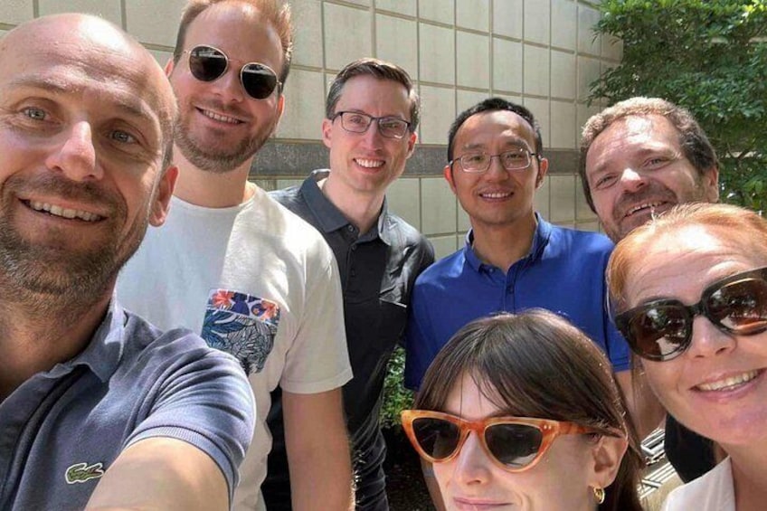 A group of people outdoors, possibly at a social gathering or event. 2