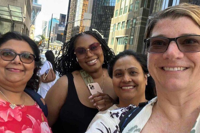 A group of people in an urban setting with tall buildings in the background. 3