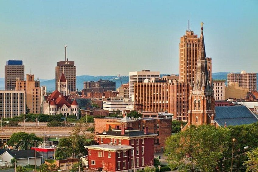 A cityscape with a prominent church, several high-rise buildings, and a mix of residential and commercial structures. 5