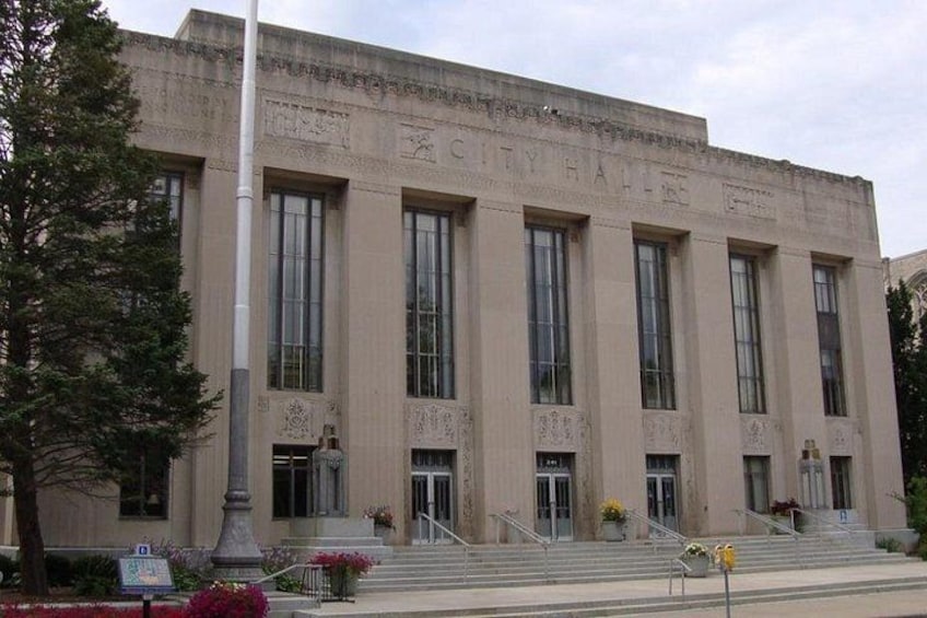 A large, historic building with a prominent entrance and steps leading up to it. 2