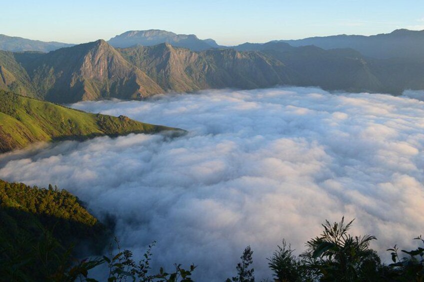 A mountainous landscape with a valley covered in clouds. 5