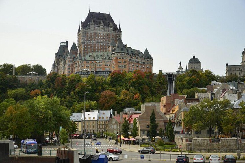 A historic building with a castle-like structure, surrounded by trees and urban buildings. 2