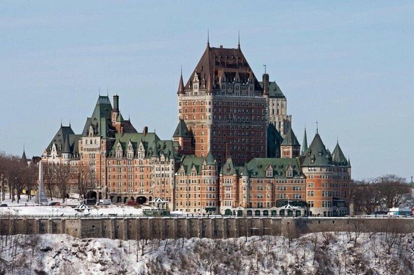 A large, historic building with multiple towers and a prominent central tower. 5