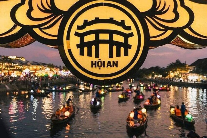 A nighttime river scene with illuminated boats and a prominent sign with traditional architecture. 4