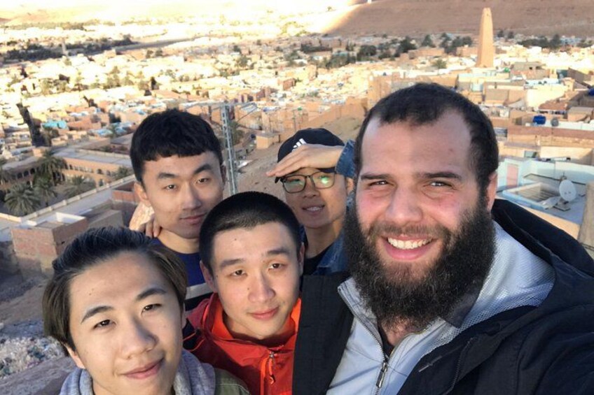 A group of people on a rooftop with a cityscape in the background. 4