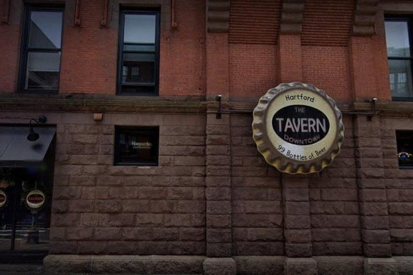 A brick building with a sign that reads 'The Tavern Downtown' and 'Hartford 99 Bottles of Beer.' 3