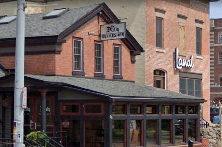 A building with a sign that reads 'Dairy Refresher' and another sign that says 'Lana.' 4